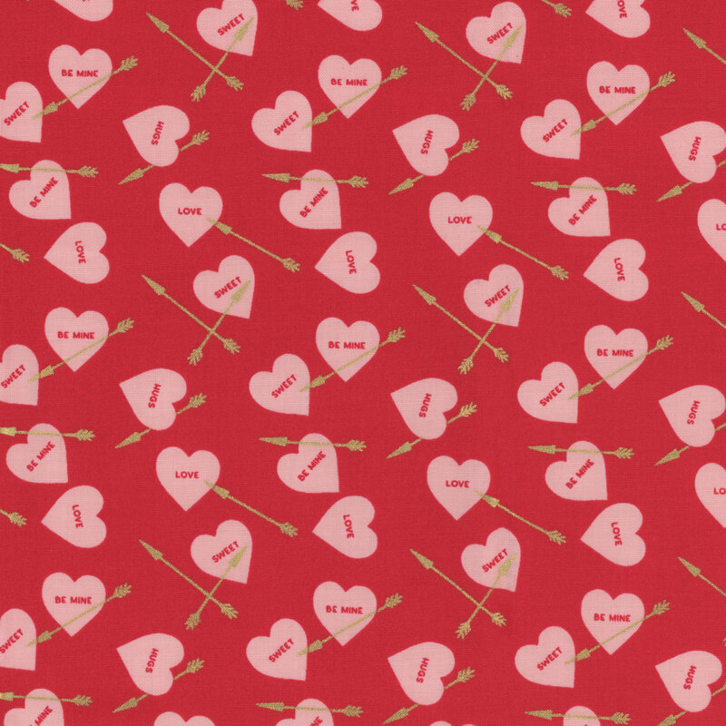 Bright red fabric with small pink ditsy hearts and golden arrows throughout