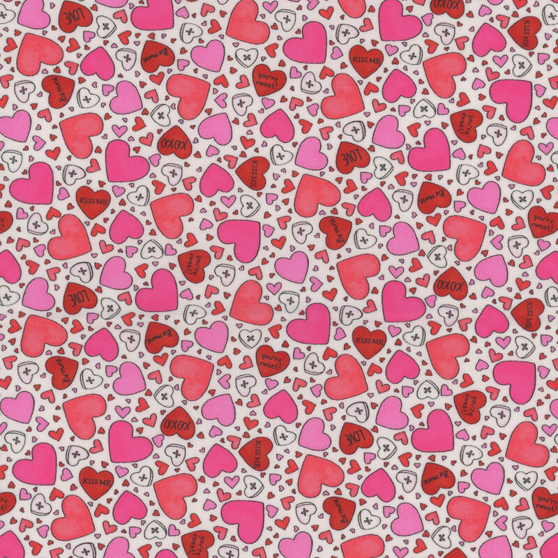 White fabric covered in red, pink, and white hearts of varying sizes