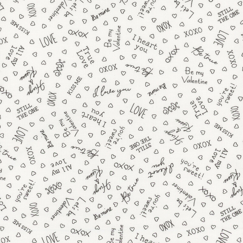 White fabric with black outlines of hearts and Valentine's Day phrases such as 