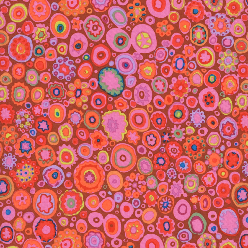 Intricate dark red fabric with bright purple, yellow, and pink spots of various shapes and sizes all over
