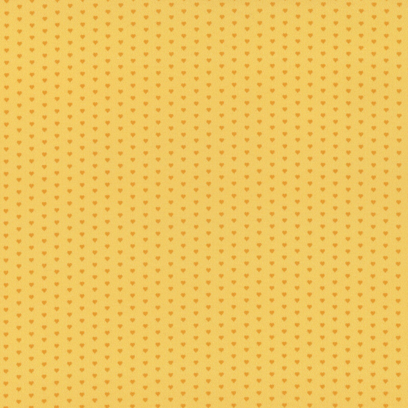 Yellow fabric with a pattern of mini golden hearts