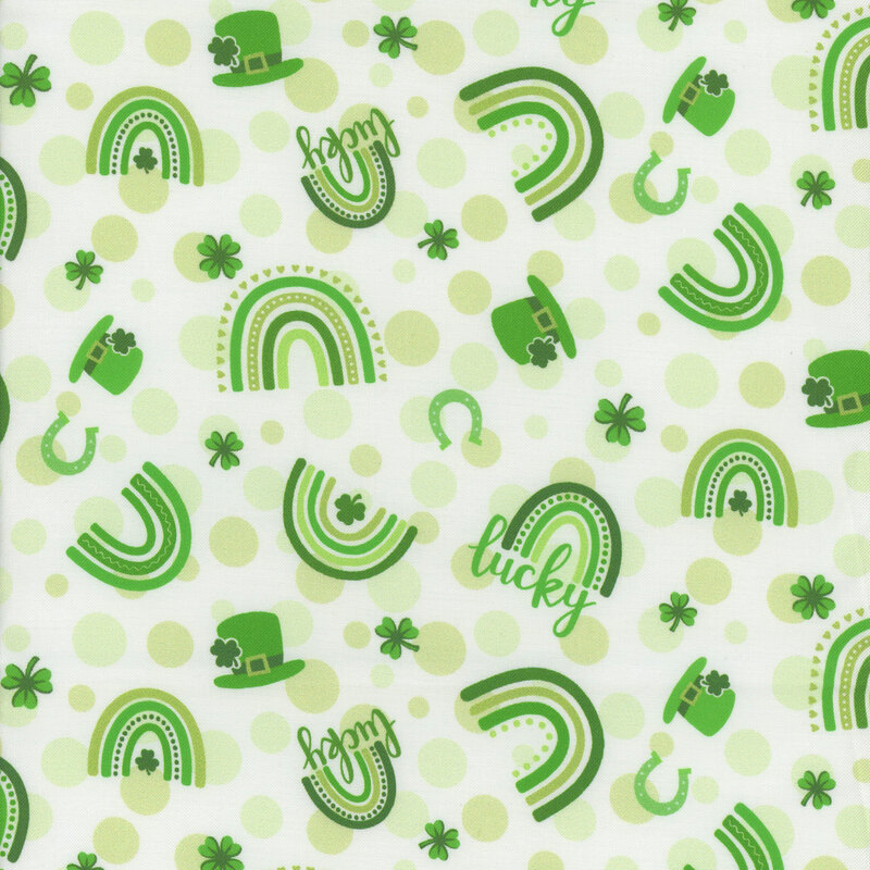 white fabric with light lime green dots tossed with rainbows, shamrocks, hats, horseshoes and the word 