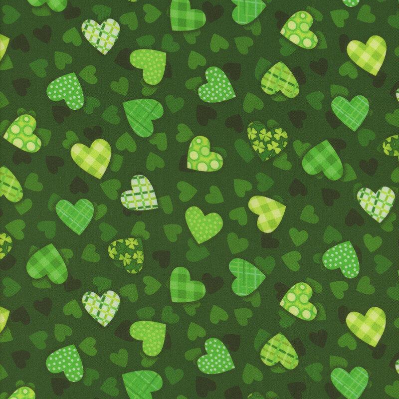 Dark green fabric with mini green and black hearts tossed with larger hearts filled with a design