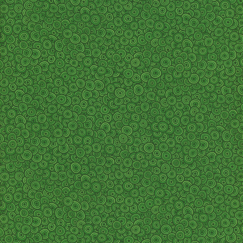 Tonal green fabric featuring a packed design of swirly circles