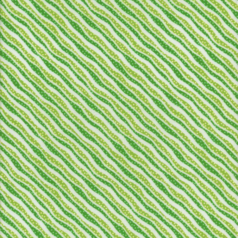 white fabric with diagonal stripes of squiggly lime green and green lines with polka dots