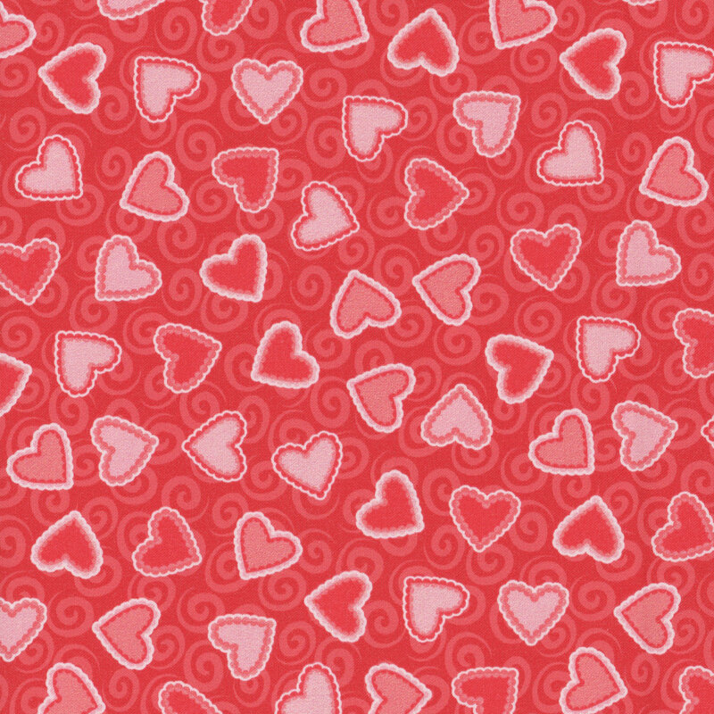 red fabric with pink and red scalloped hearts and tonal swirls in the background