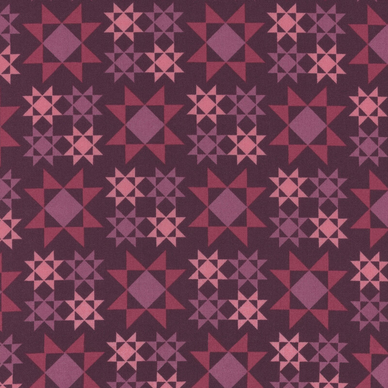 plum fabric with large dark pink and purple Sawtooth Star quilt block patterns scattered across the fabric with smaller versions in purple and pink are arranged in a square formation between the larger ones