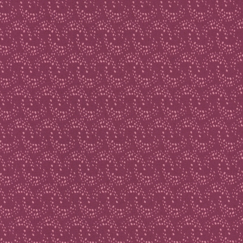 rouge fabric with overlapping rows of light pink arcing dots 