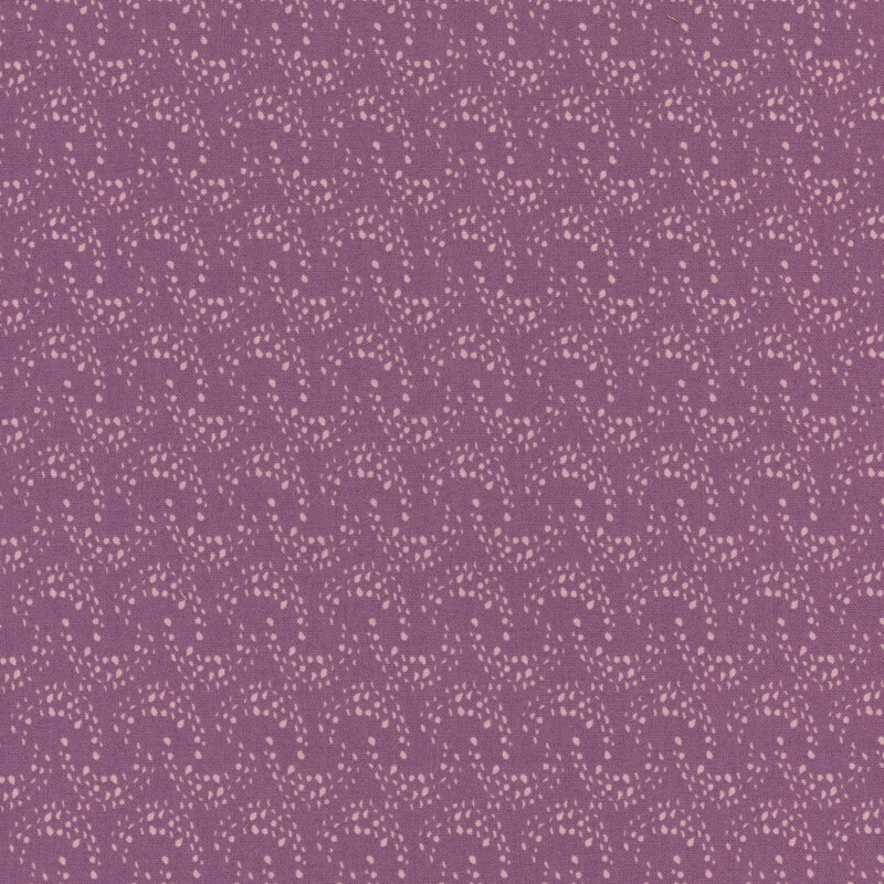 purple fabric with overlapping rows of light pink arcing dots 