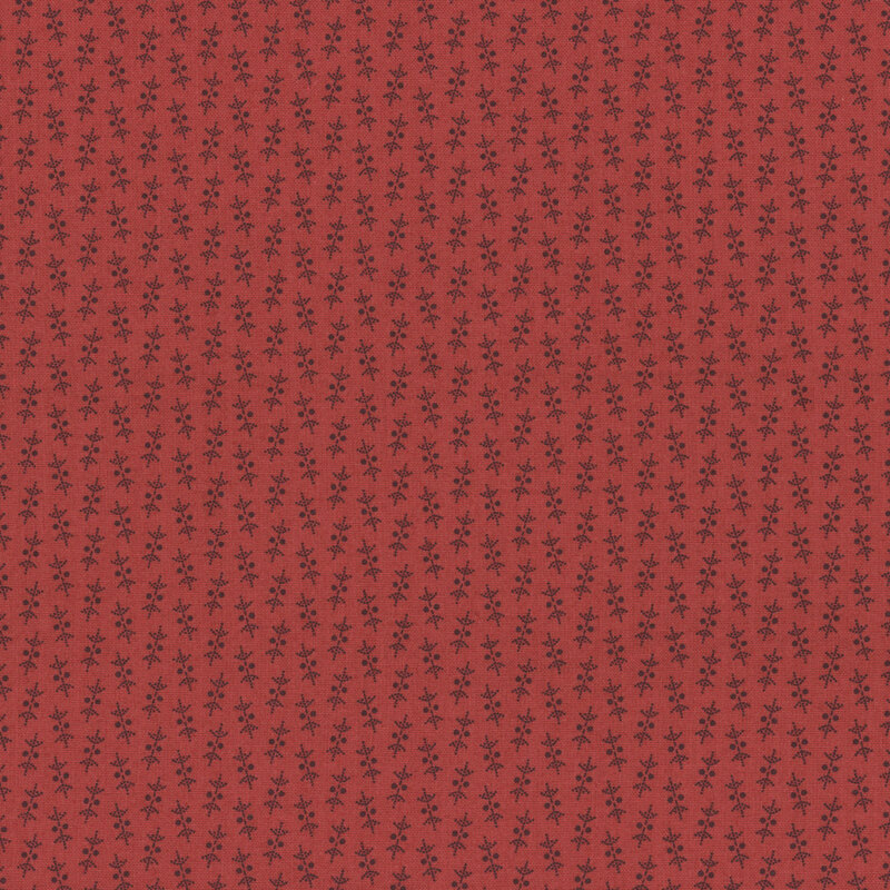 Red fabric featuring small berry leaf sprigs