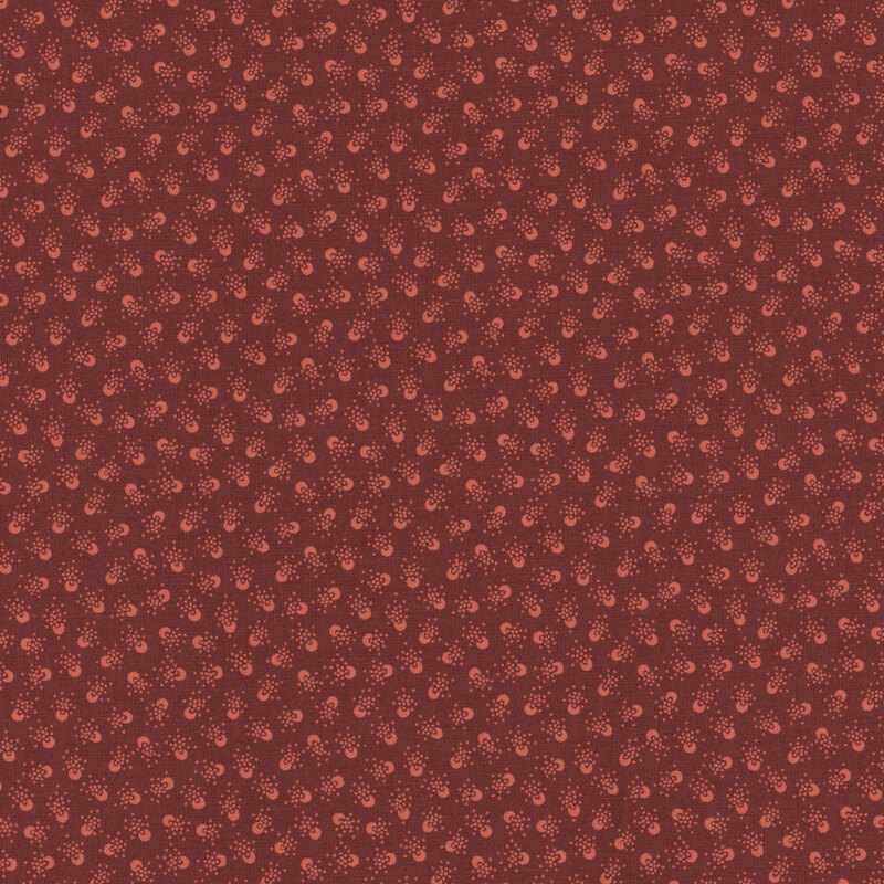 Burgundy red fabric featuring crescent circles surrounded by dots