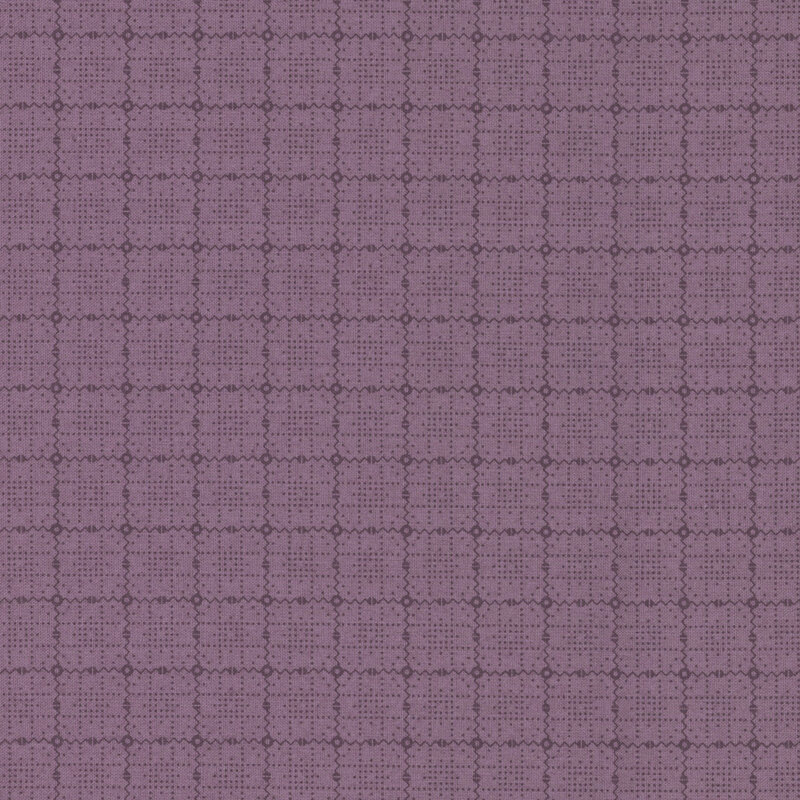 Mauve tonal fabric with a geometric design of dots and squiggly lines