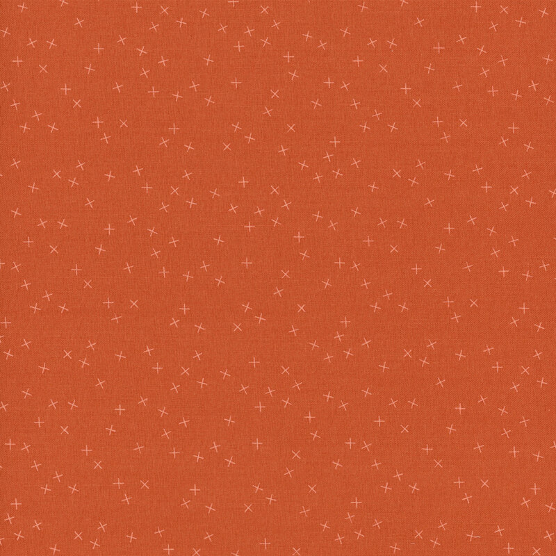 Dark orange fabric with small light X's scattered throughout