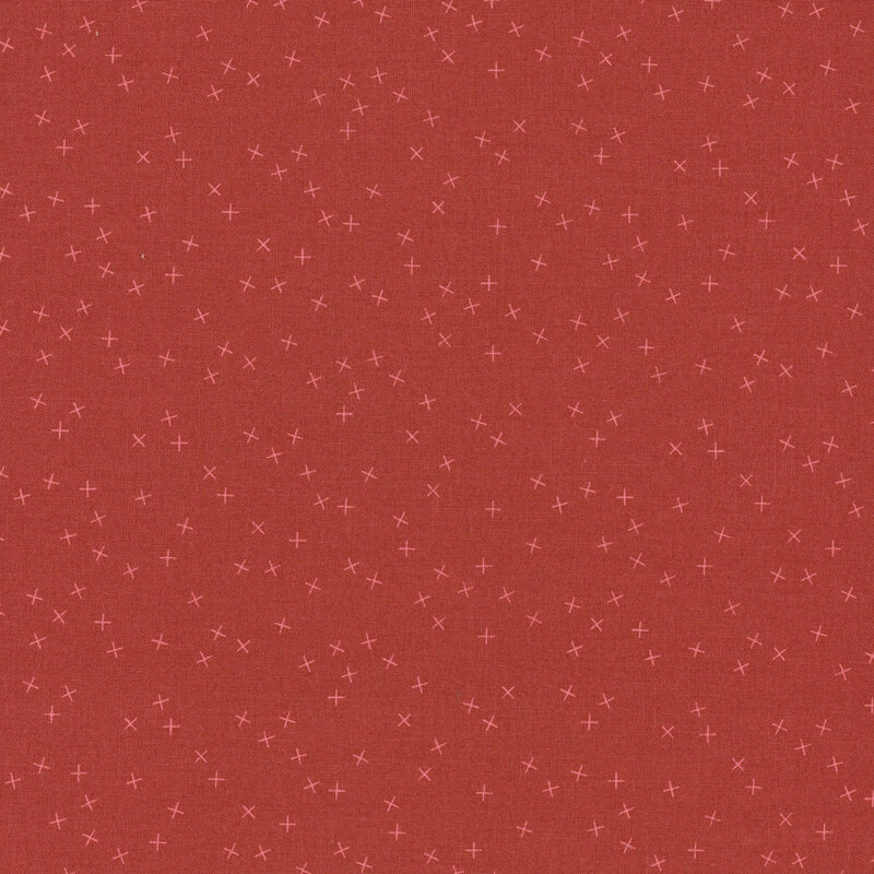 Red fabric with small, tonal X's scattered throughout