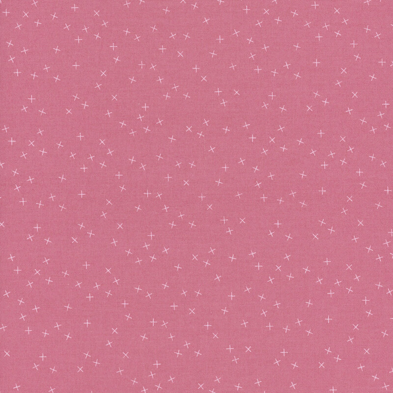 Pink fabric with small white X's scattered throughout