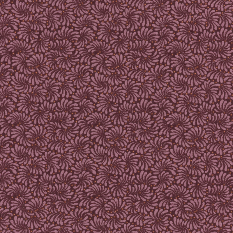 Plum colored fabric with a repeating intricate swirled pattern throughout