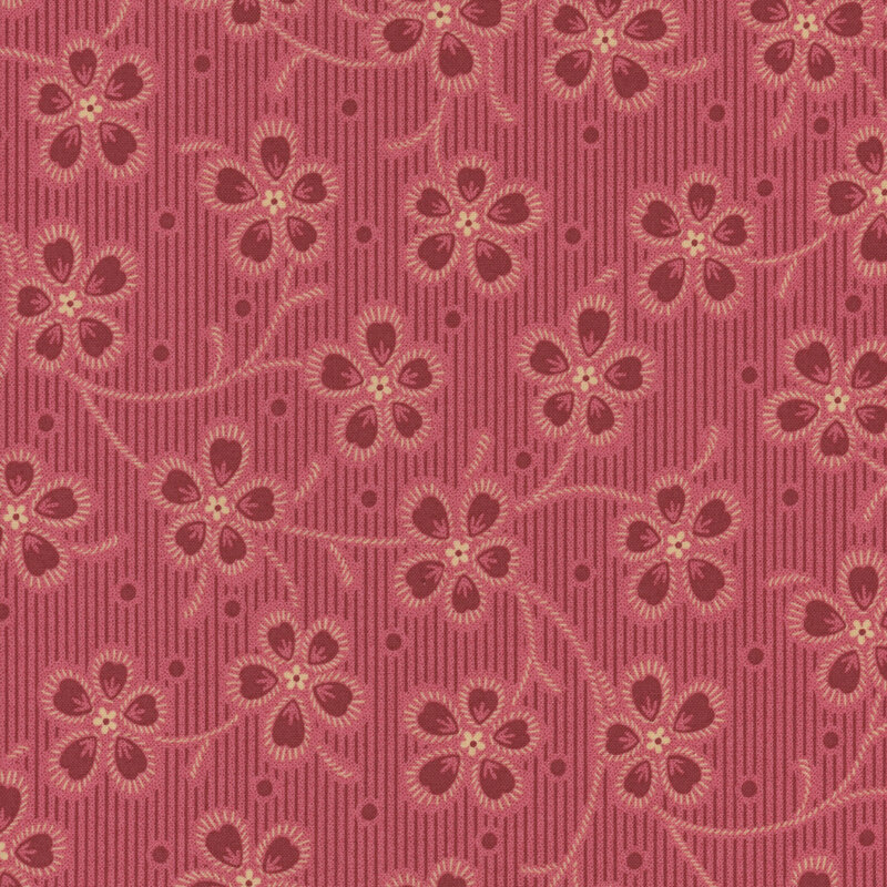 Pink fabric with a red striped background and large red florals outlined in light pink throughout