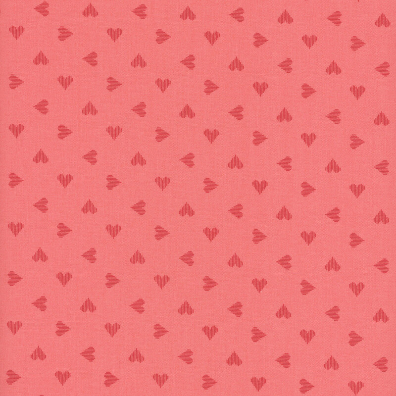 pink fabric featuring ditsy red hearts