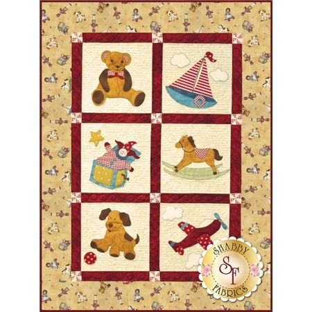 Patchwork quilt featuring six playful designs: a teddy bear, sailboat, clown, rocking horse, dog, and airplane.