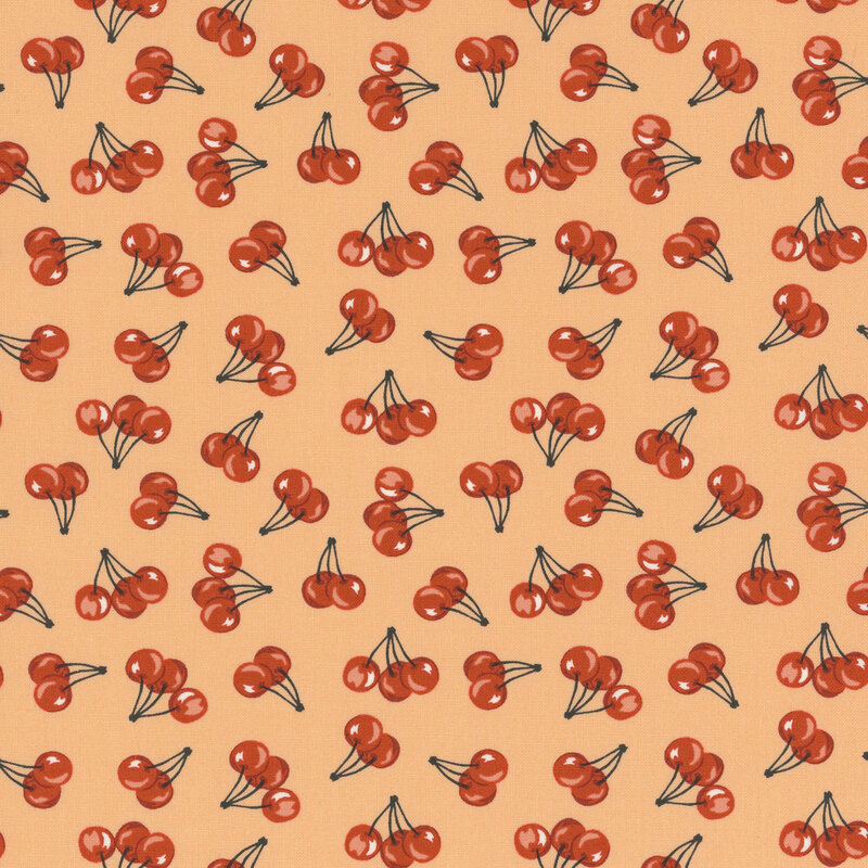 Peach fabric with scattered cherry pattern