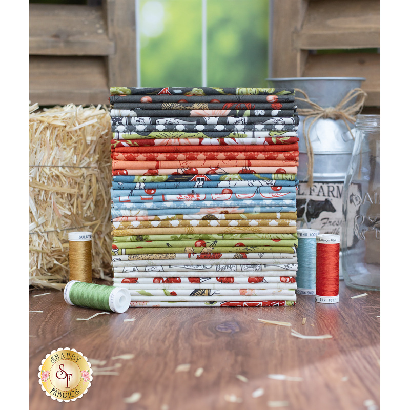 A Farmstead 33 FQ Set surrounded by hay and galvanized jugs.