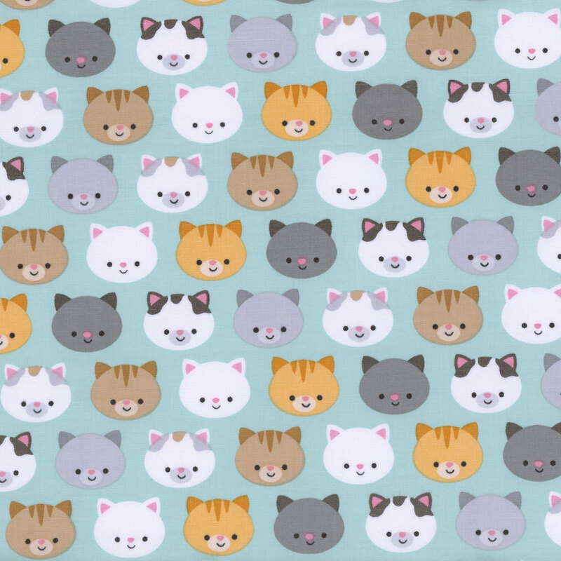 aqua fabric with colorful orange, black, gray, and white cat faces all over