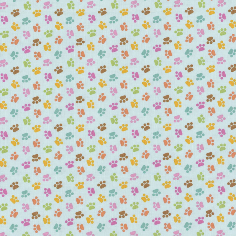 Blue sewing fabric with colorful ditsy cat paw prints throughout