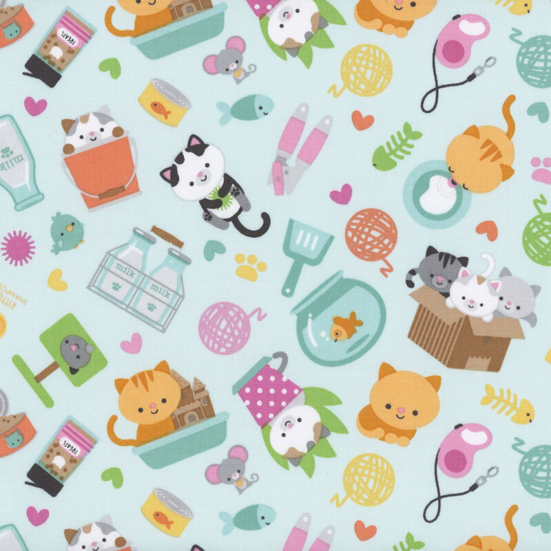 blue sewing fabric with tossed cats, gold fish, and other household items