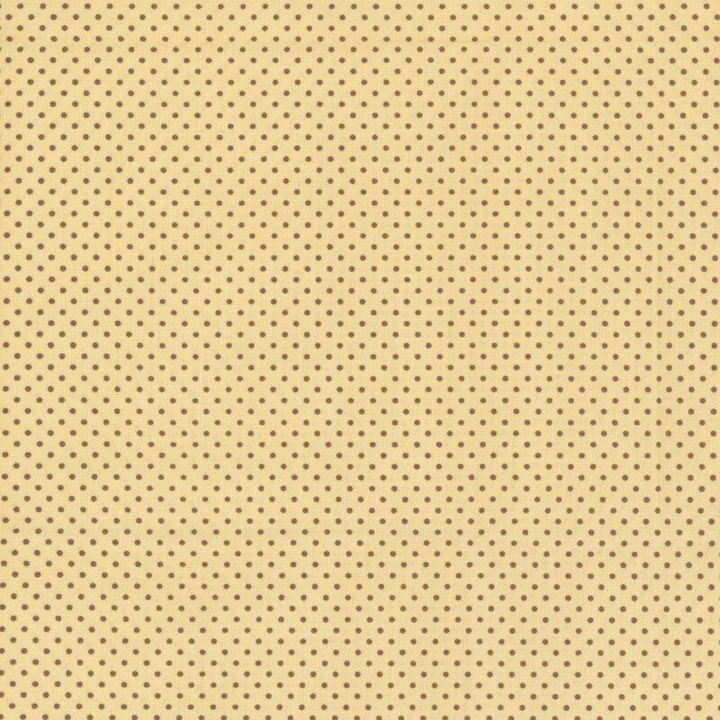 pastel yellow fabric with small brown polka dots all over