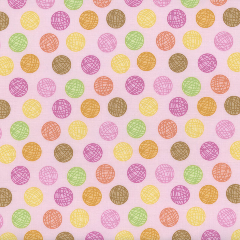 pink sewing fabric with colorful balls of yarn polka dots all over