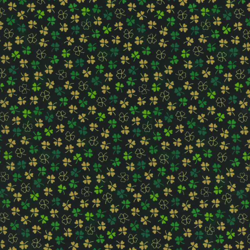 Dark green mottled fabric with small green and tan ditsy shamrocks throughout