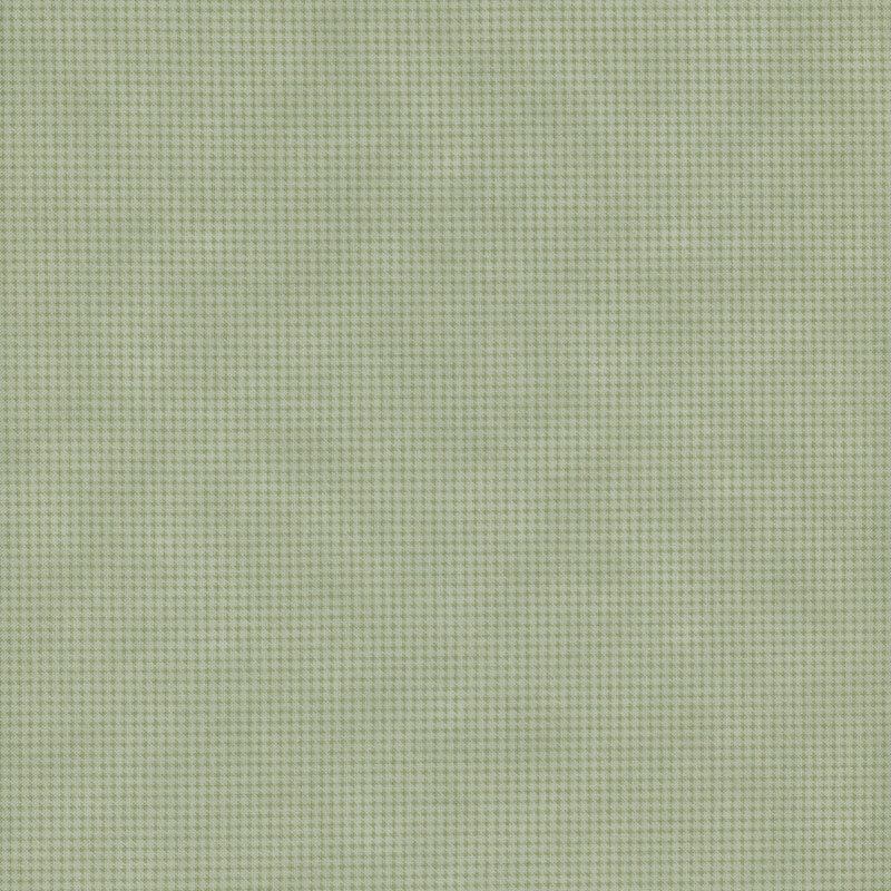 Mottled sage green fabric with a small, repeating, dotted texture throughout