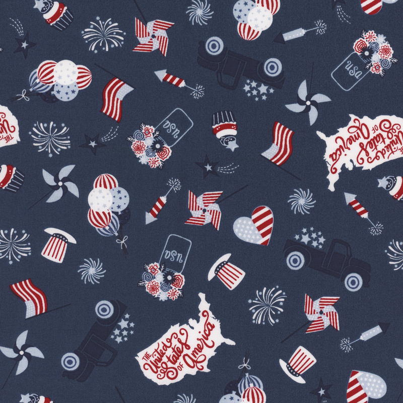 blue fabric with tossed trucks, american flags, hearts with american flag designs, pinwheels, and other patriotic motifs