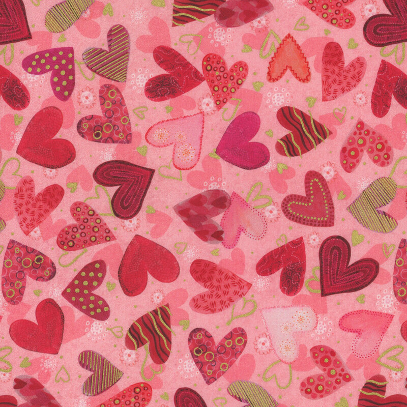 Pink fabric with layers of light pink, gold, and red hearts with various designs all over