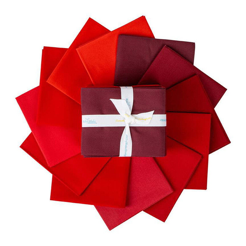 The fat quarters included in the set, fanned out in an appealing circle, isolated on a white background.