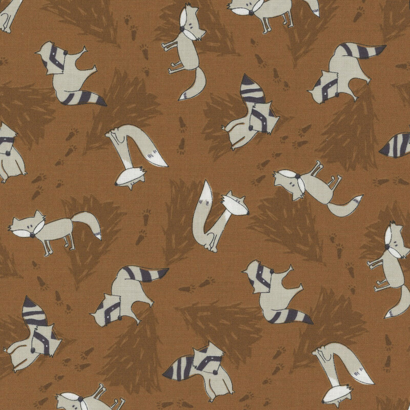 Brown fabric with darker brown pine trees in the background and illustrated racoons and wolves tossed throughout