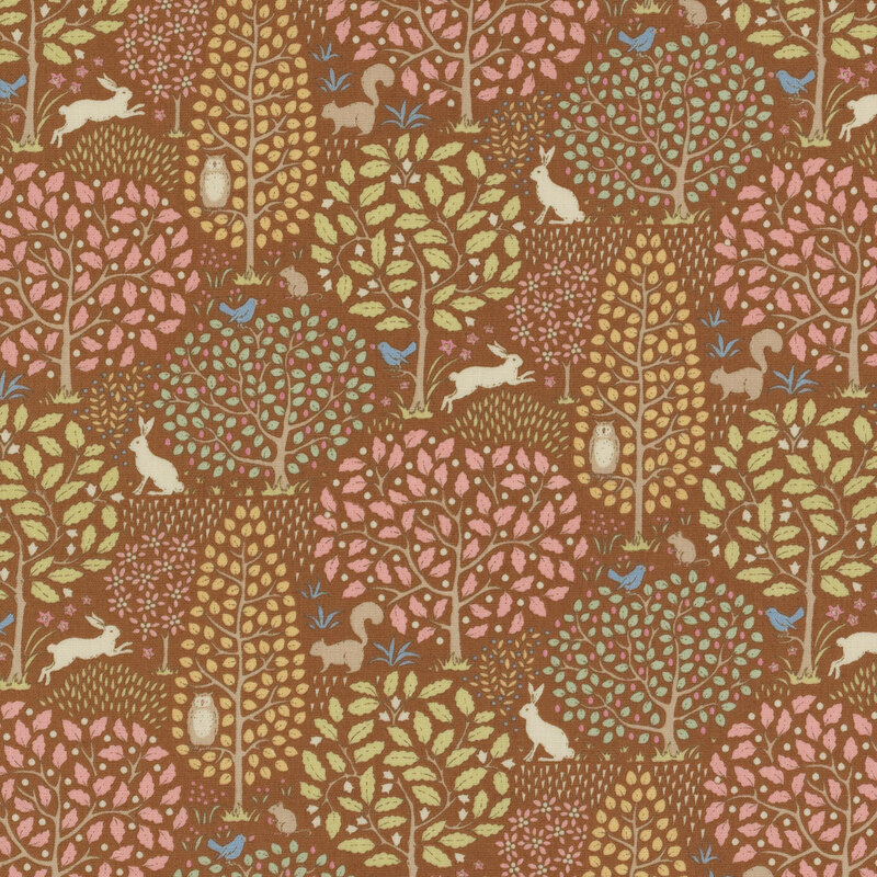 Caramel brown fabric with large orange, pink, and green leafy trees and rabbits, squirrels, birds, and owls scattered across the scenery.