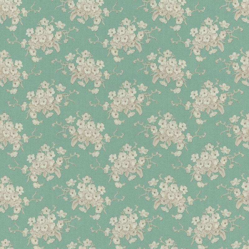 Teal fabric with clusters of cream floral bouquets.