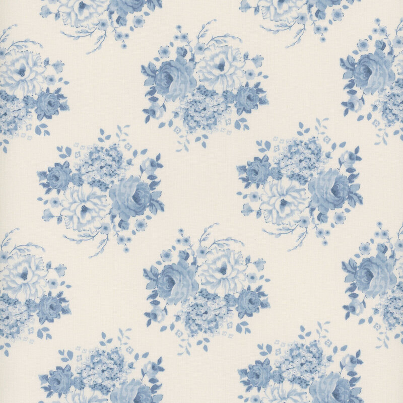 Cream fabric with clusters of blue floral bouquets.