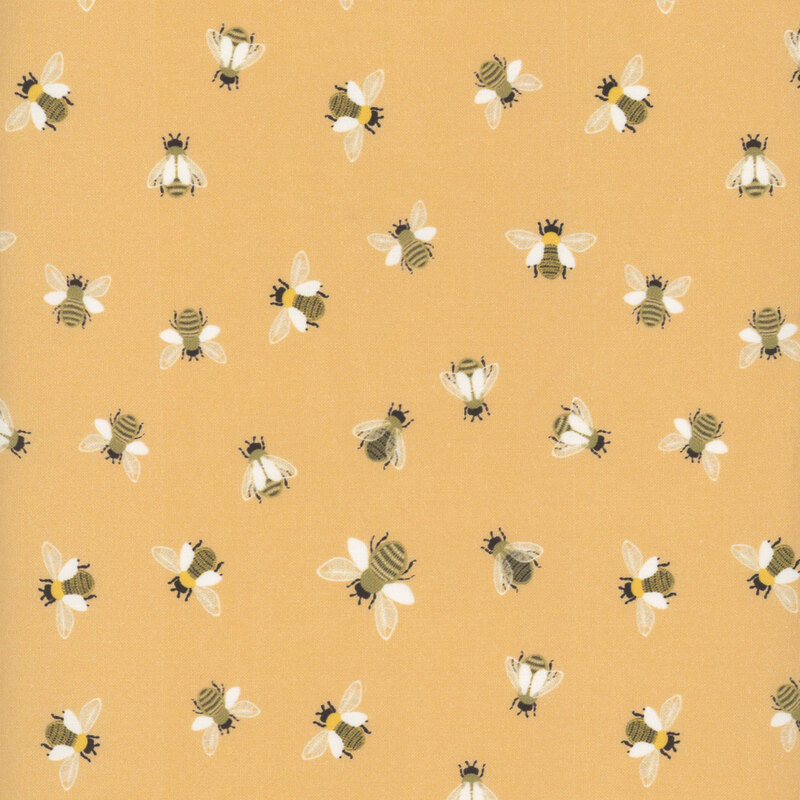 Honey yellow fabric with scattered bees flying and in place from a top-down view.