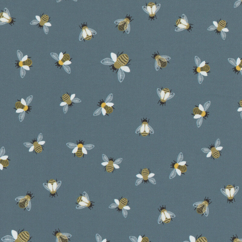 Blue fabric with scattered bees flying and in place from a top-down view.