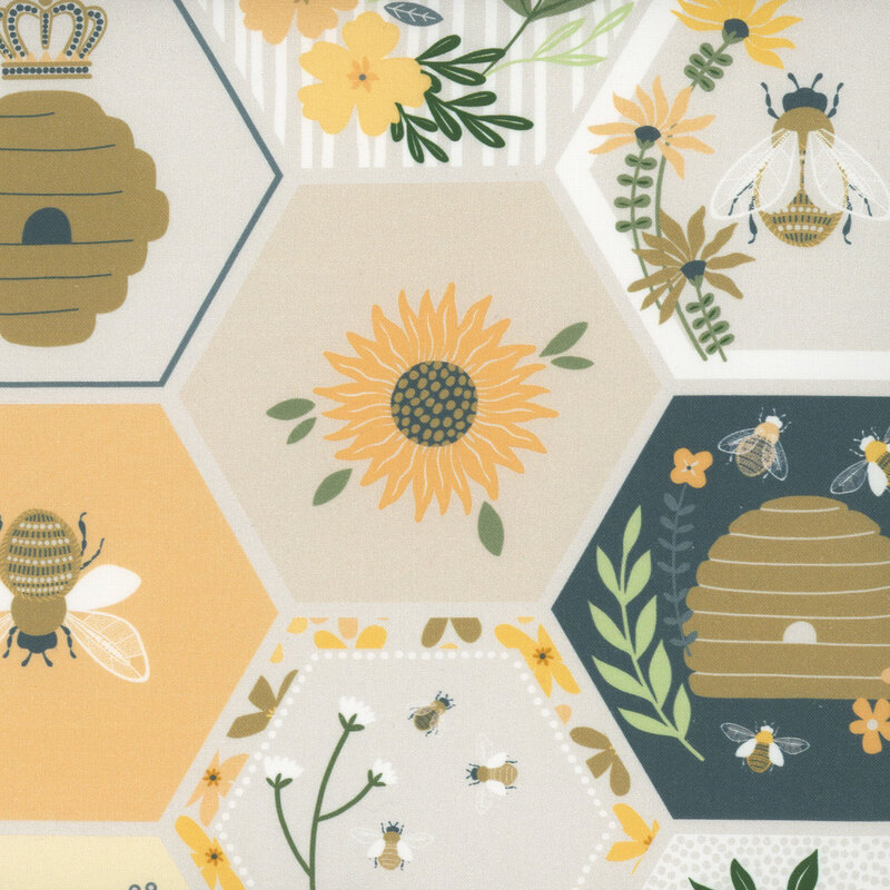 Multicolored fabric sorted in neutral, blue, and yellow honeycombs with scattered bee motifs.