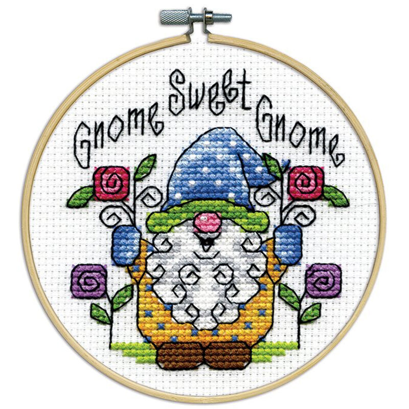 A closeup of the finished Gnome cross stitch inside a wooden hoop isolated on a white background.