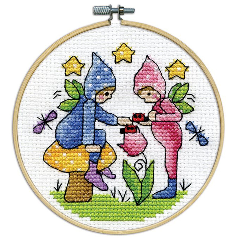 A closeup of the finished Fairies cross stitch inside a wooden hoop isolated on a white background.