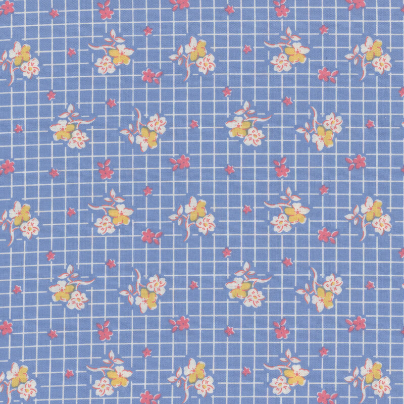 Blue fabric with white, pink and yellow flowers in rows on a white gridded background.