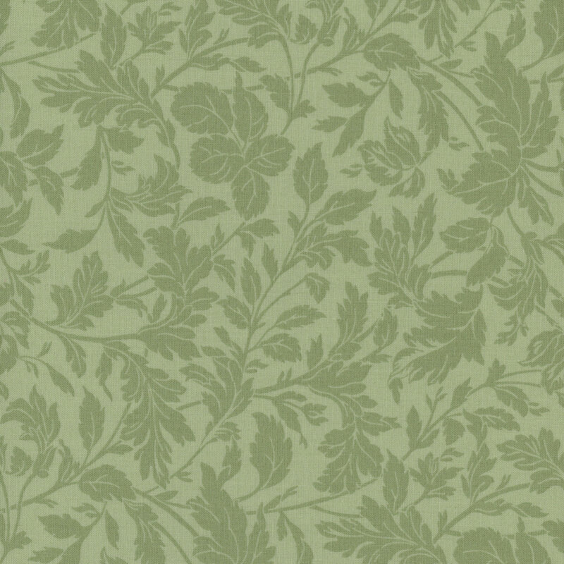 A swatch of tonal green fabric with branching leaves and stems.