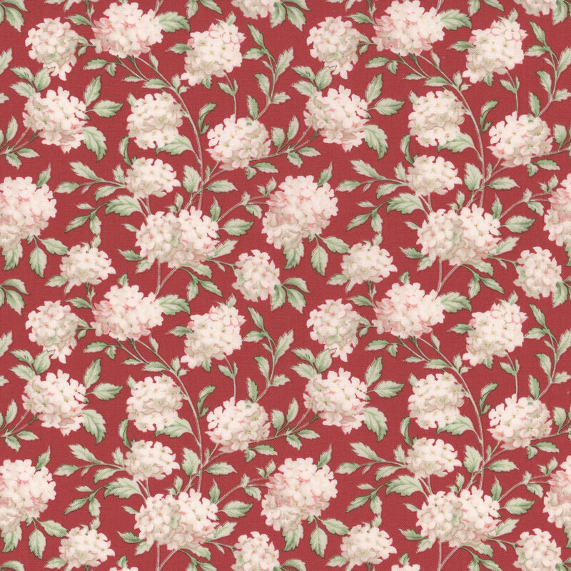 A swatch of red fabric with scattered bunches of pinkish white hydrangea flowers.