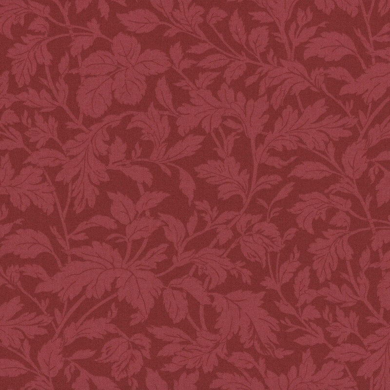 A swatch of tonal red fabric with branching leaves and stems.