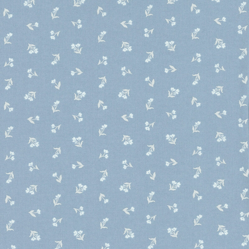 Medium blue fabric with outlines of off white florals with stems in a ditsy pattern