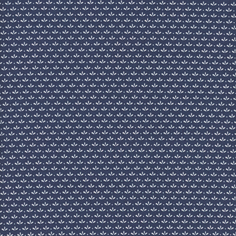 Navy fabric with uniform rows of simplified white flower blossoms with tiny polka dots between each.